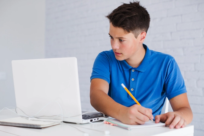 Student using Lecture Notes Summarizer Tool on laptop during late-night study session