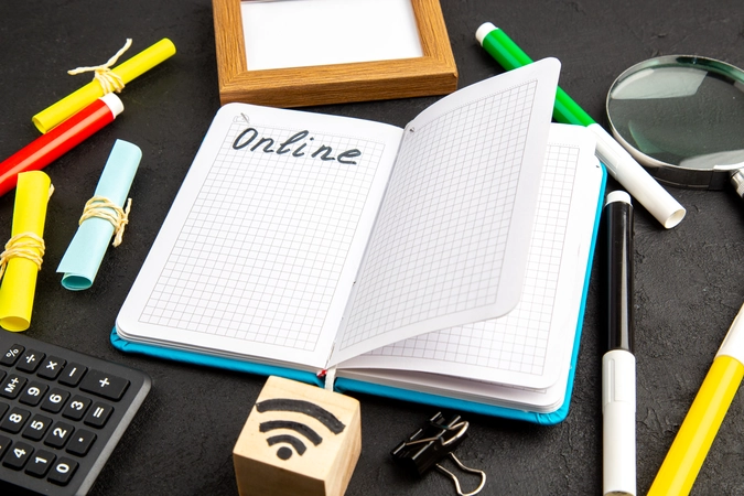 Online Learning Supplies – Notebook, Pens, Wi-Fi Block, Calculator symbolizing digital education setup